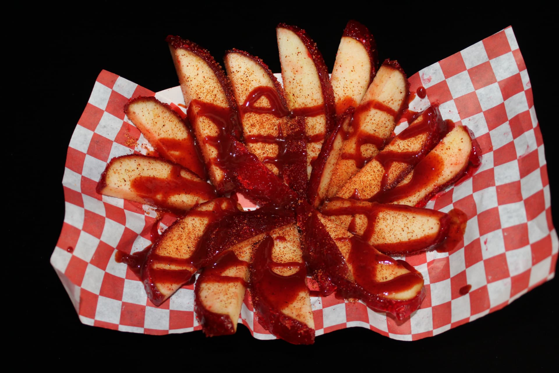 Chamoy apple slices fanned out with chile powder