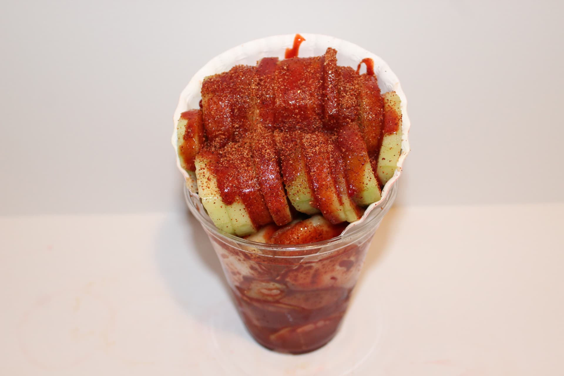Cucumber cup loaded with chamoy and Lucas